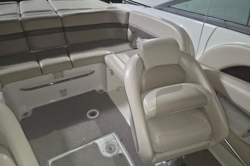 Slide: The Image of Interior of a 2006 Chaparral 236 SSi boat with beige seating and carpeted floor. - 5