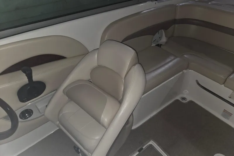 Slide: The Image of 2006 Chaparral 236 SSi boat interior with beige seating and steering wheel. - 7