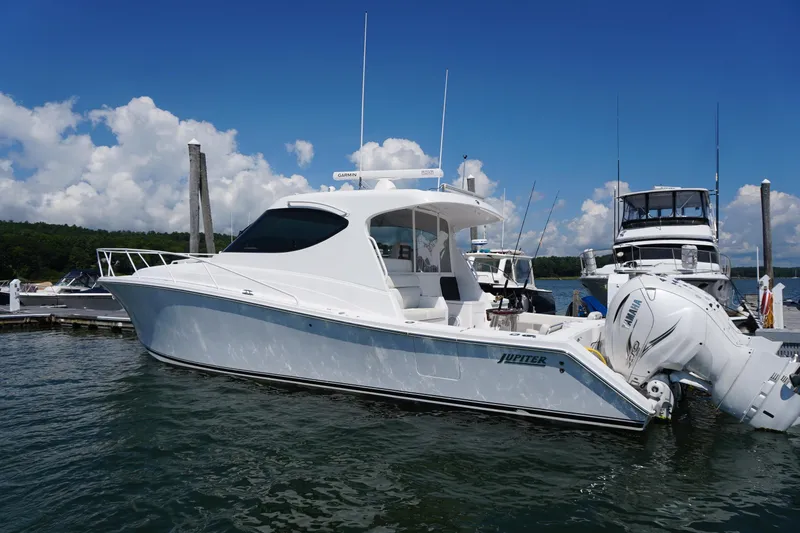 The Image of 2021 Jupiter 41 SB boat docked at marina under clear blue sky. - 0