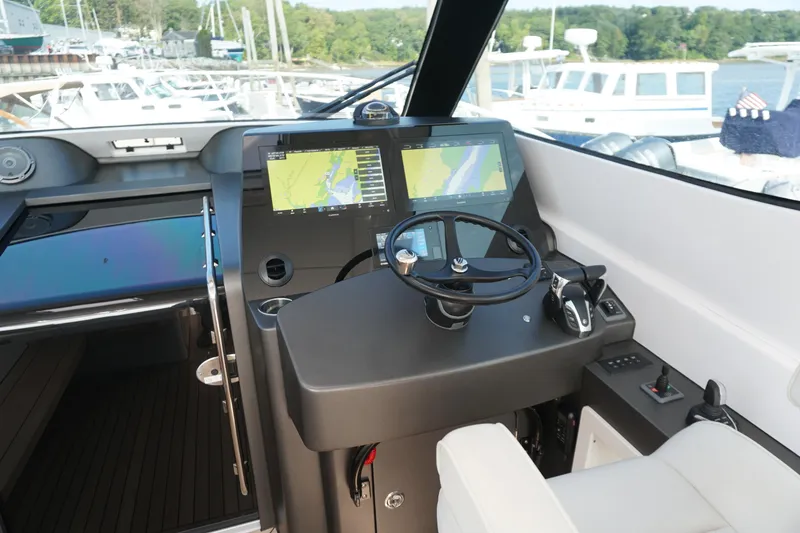 Slide: The Image of Helm of 2021 Jupiter 41 SB boat with navigation screens and steering wheel. - 16