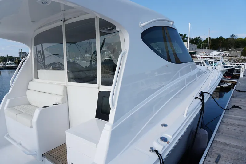 Slide: The Image of 2021 Jupiter 41 SB yacht docked, showcasing sleek design and spacious seating area. - 2