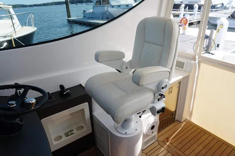 Slide: The Image of Interior of a 2021 Jupiter 41 SB boat with captain's chair. - 21