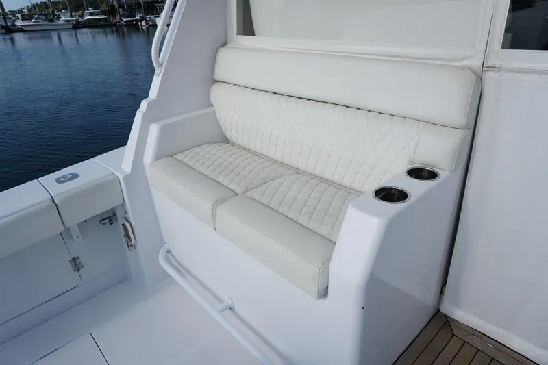 Slide: The Image of Luxurious seating on 2021 Jupiter 41 SB boat with quilted upholstery and cup holders. - 23