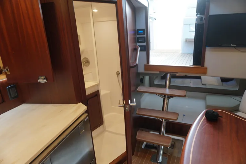 Slide: The Image of Interior of 2021 Jupiter 41 SB yacht with wooden stairs and kitchenette. - 30