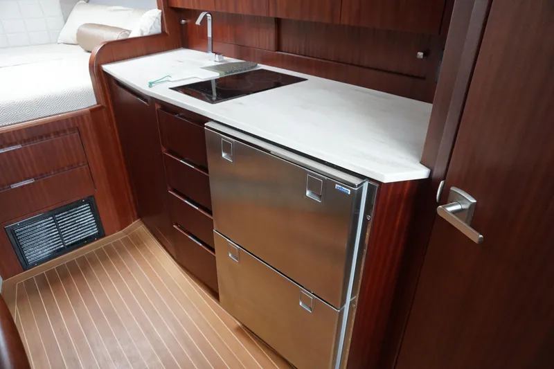 Slide: The Image of Luxurious 2021 Jupiter 41 SB yacht interior with modern kitchenette and stainless steel appliances. - 42