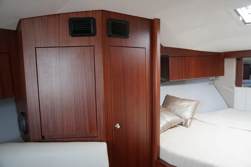 Slide: The Image of Luxurious interior of 2021 Jupiter 41 SB yacht with wood paneling and cozy bedding. - 44