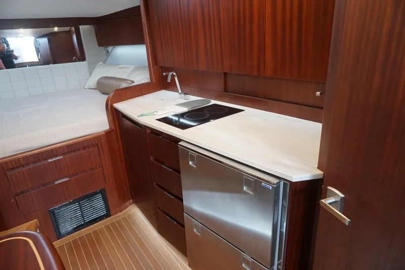 Slide: The Image of Luxurious 2021 Jupiter 41 SB yacht interior with kitchenette and cozy sleeping area. - 51
