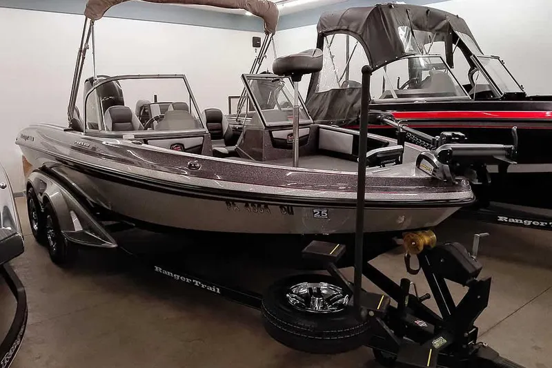 The Image of 2018 Ranger 1880MS Angler boat displayed indoors on a trailer. - 1