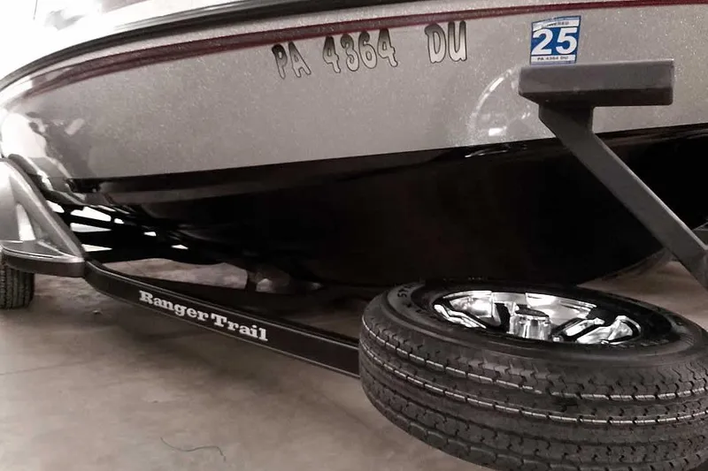 Slide: The Image of 2018 Ranger 1880MS Angler boat on trailer, close-up view of hull and tire. - 10