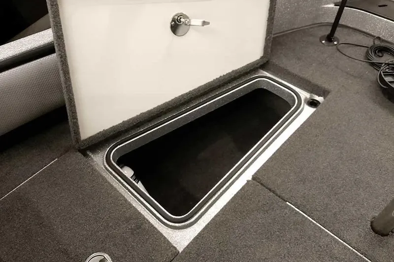 Slide: The Image of Open storage compartment in 2018 Ranger 1880MS Angler boat, featuring carpeted interior. - 25