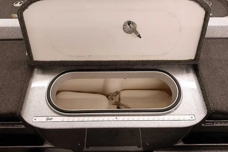 Slide: The Image of Open storage compartment in 2018 Ranger 1880MS Angler boat, featuring a measuring ruler. - 34
