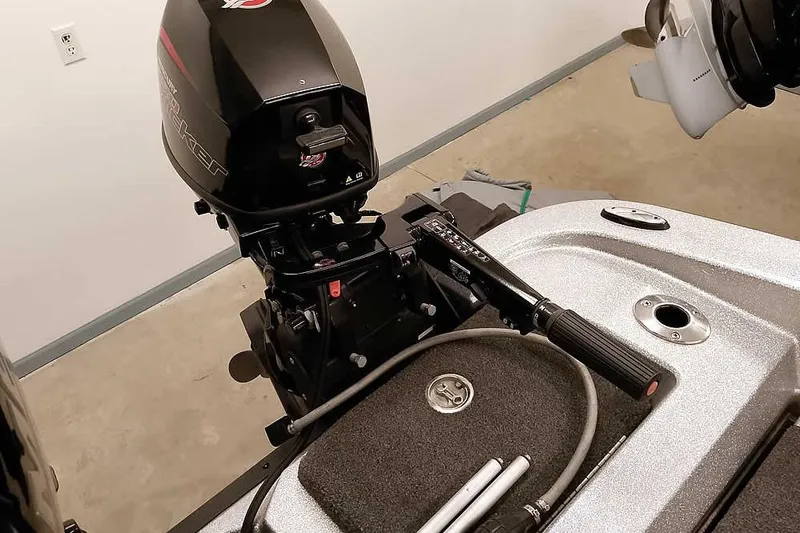 Slide: The Image of 2018 Ranger 1880MS Angler boat motor and deck in a garage setting. - 36