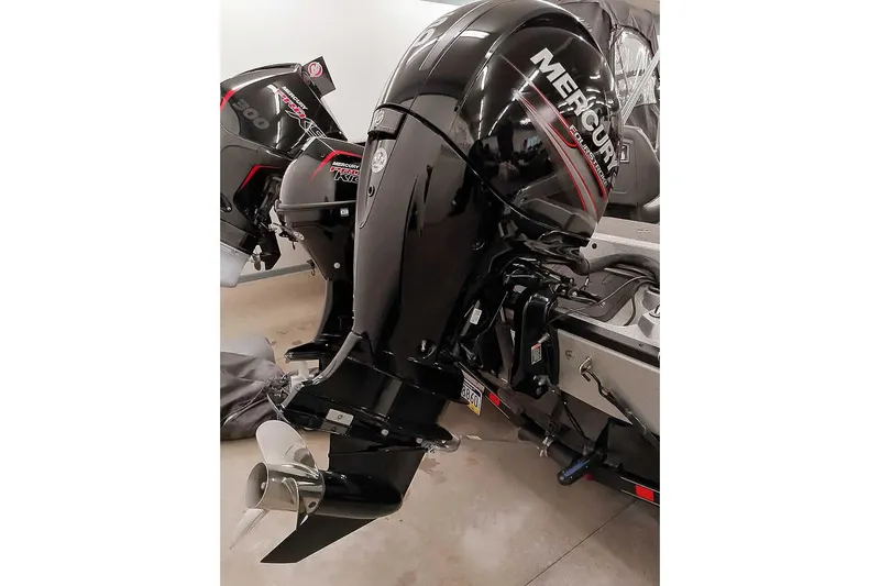 Slide: The Image of 2018 Ranger 1880MS Angler with Mercury outboard motor in a garage setting. - 7