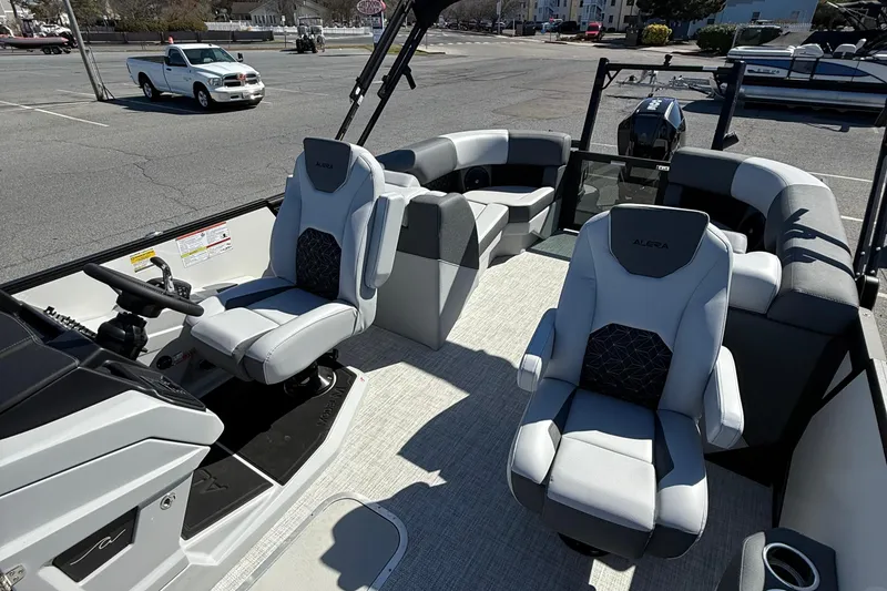 Slide: The Image of Interior of 2026 Alera M23Q boat with modern seating and steering console. - 10