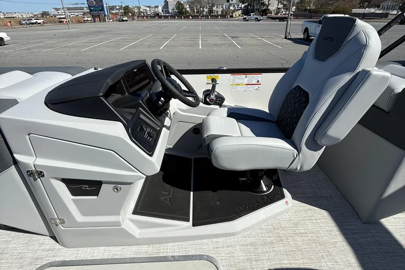 Slide: The Image of Interior of 2026 Alera M23Q boat with modern helm and comfortable seating. - 12