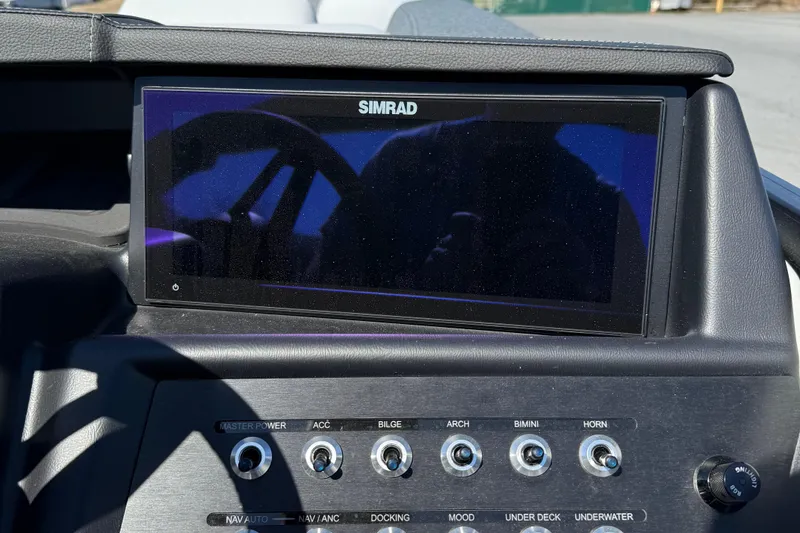 Slide: The Image of Dashboard of Alera M23Q 2026 boat with Simrad display and control switches. - 15