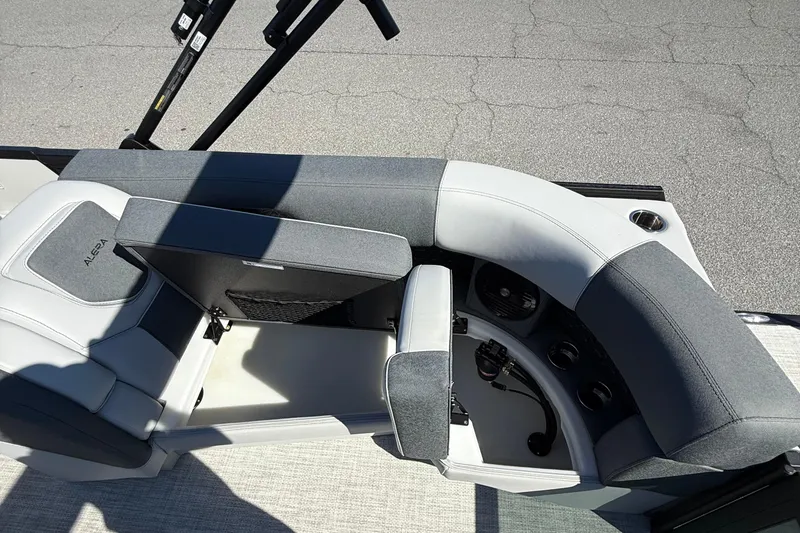 Slide: The Image of 2026 Alera M23Q boat interior with gray seating and storage compartments. - 17