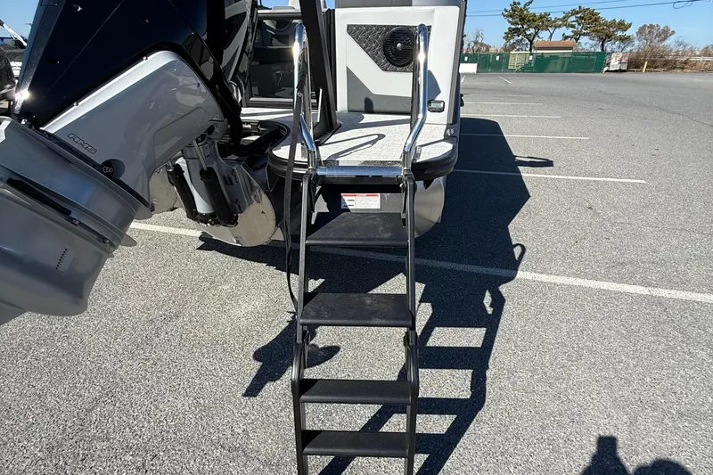Slide: The Image of Alera M23Q 2026 boat with ladder and motor in parking lot. - 20