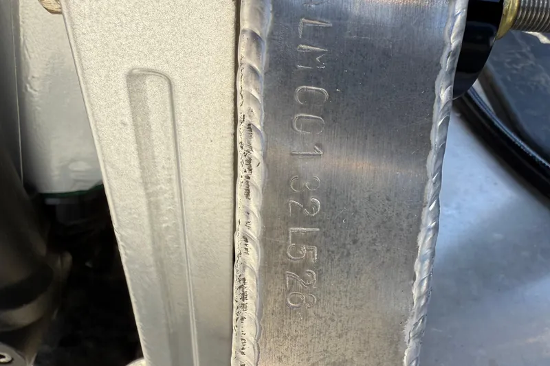 Slide: The Image of Close-up of Alera M23Q 2026 metal component with engraved serial number. - 22