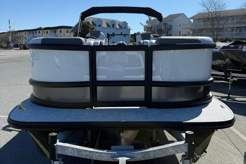 Slide: The Image of 2026 Alera M23Q pontoon boat parked in a marina with modern design. - 3