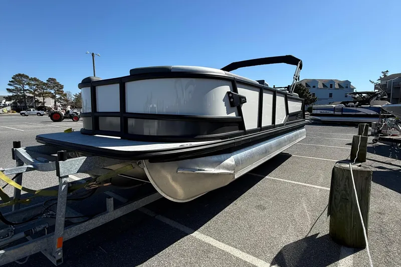 Slide: The Image of 2026 Alera M23Q pontoon boat on trailer in parking lot. - 4