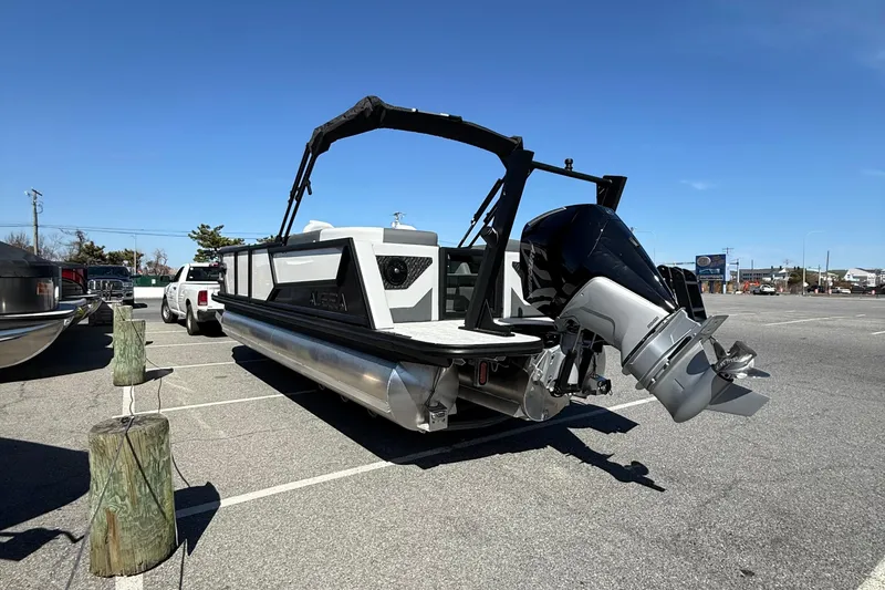 Slide: The Image of 2026 Alera M23Q pontoon boat with outboard motor in parking lot. - 6