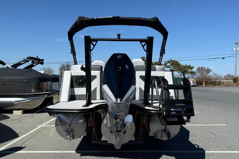 Slide: The Image of 2026 Alera M23Q boat with sleek design and powerful engine, parked outdoors. - 7