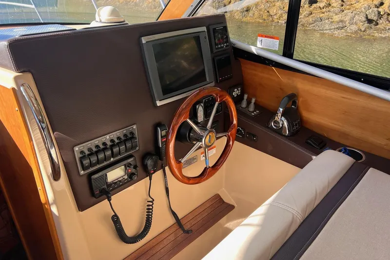 Slide: The Image of 2014 Cutwater C-26 helm with steering wheel, navigation controls, and display screen. - 10
