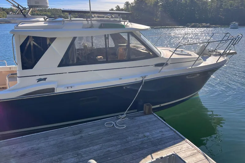 Slide: The Image of 2014 Cutwater C-26 boat docked on a sunny day by the water. - 2