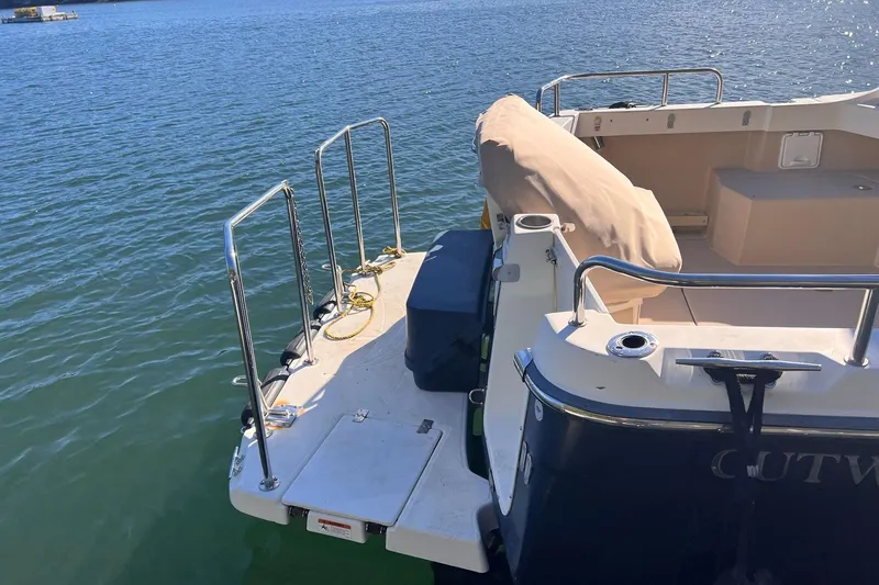 Slide: The Image of 2014 Cutwater C-26 boat stern with swim platform on calm water. - 6