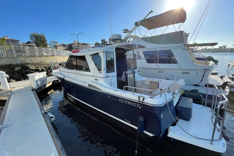 Slide: The Image of 2014 Cutwater C-26 boat docked at marina under clear blue sky. - 7