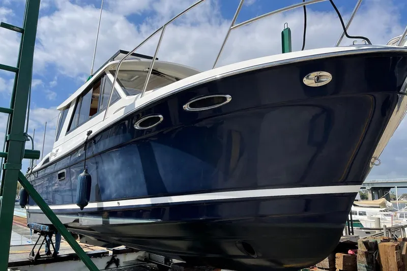 Slide: The Image of 2014 Cutwater C-26 boat on dry dock, blue hull, clear sky background. - 9
