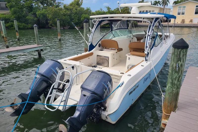 Slide: The Image of 2010 World Cat 290 DC boat docked with twin Yamaha engines. - 1