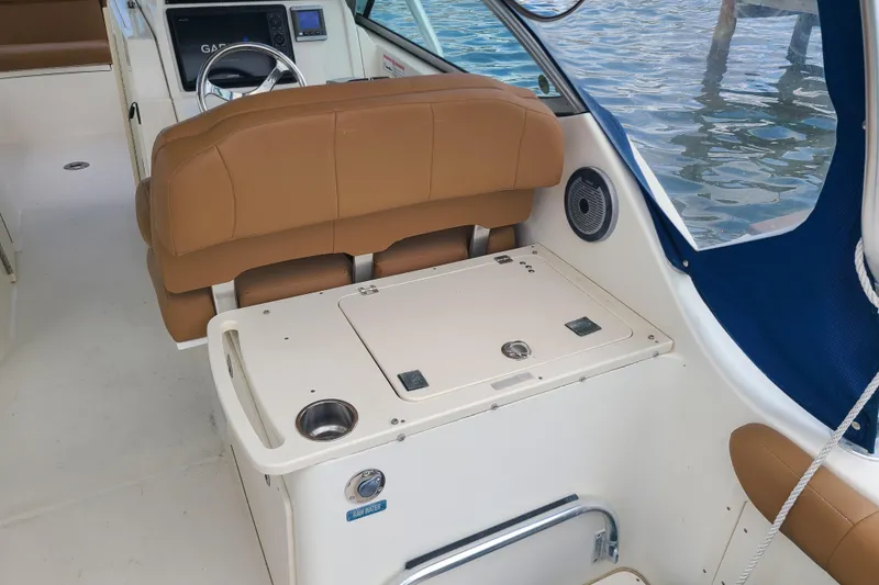 Slide: The Image of Interior of 2010 World Cat 290 DC boat with tan seating and control panel. - 11