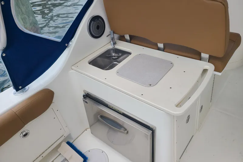 Slide: The Image of Interior of 2010 World Cat 290 DC boat with sink and seating area. - 12