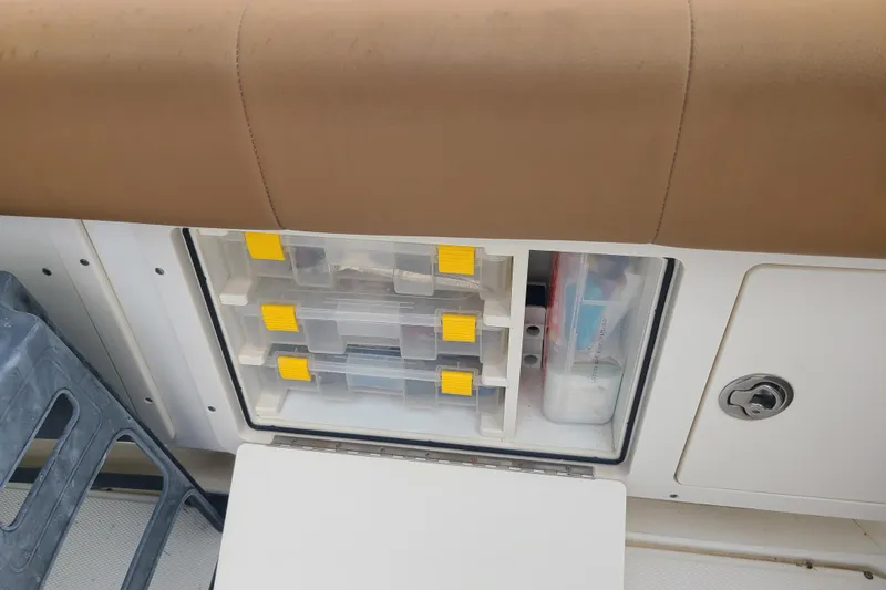 Slide: The Image of Storage compartment on a 2010 World Cat 290 DC boat with organized tackle boxes. - 15