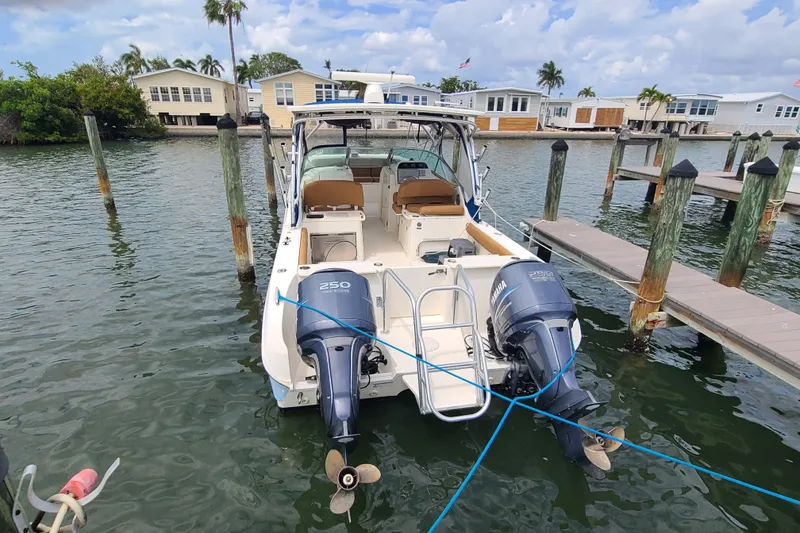Slide: The Image of 2010 World Cat 290 DC boat docked with twin Yamaha engines. - 2