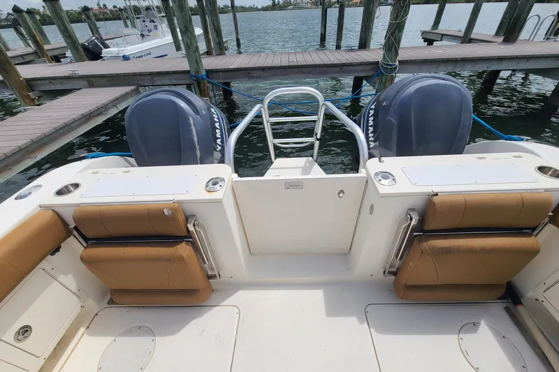 Slide: The Image of 2010 World Cat 290 DC boat with twin Yamaha engines docked at marina. - 20