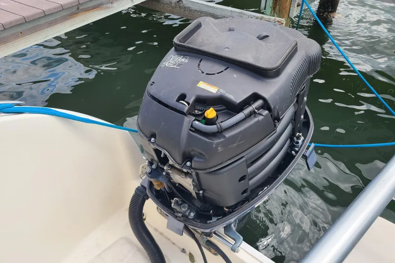 Slide: The Image of Outboard motor on a 2010 World Cat 290 DC boat docked by the water. - 22