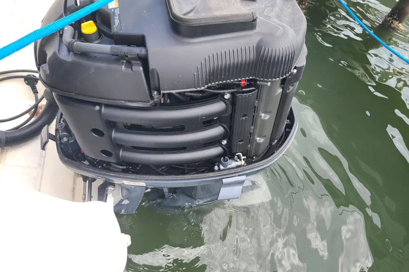 Slide: The Image of Outboard motor of a 2010 World Cat 290 DC boat in water. - 24