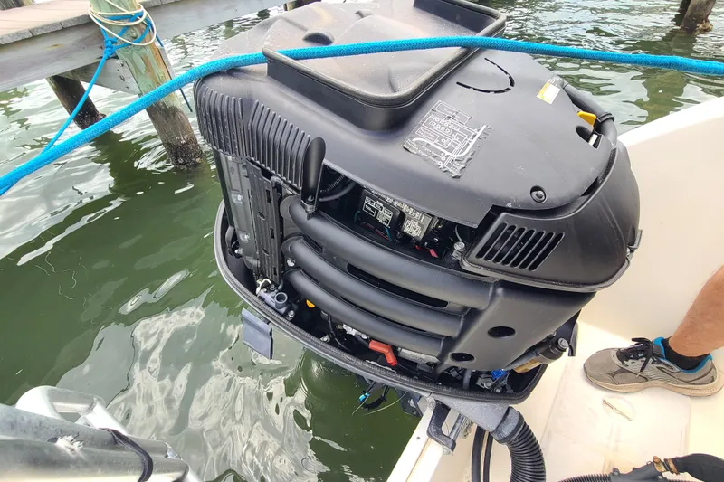 Slide: The Image of Outboard motor on a 2010 World Cat 290 DC boat, docked by the water. - 25
