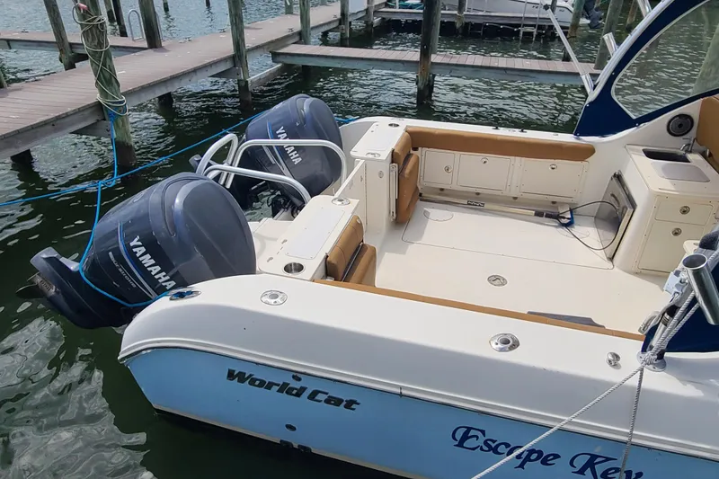 Slide: The Image of 2010 World Cat 290 DC boat with Yamaha engines docked at marina. - 4