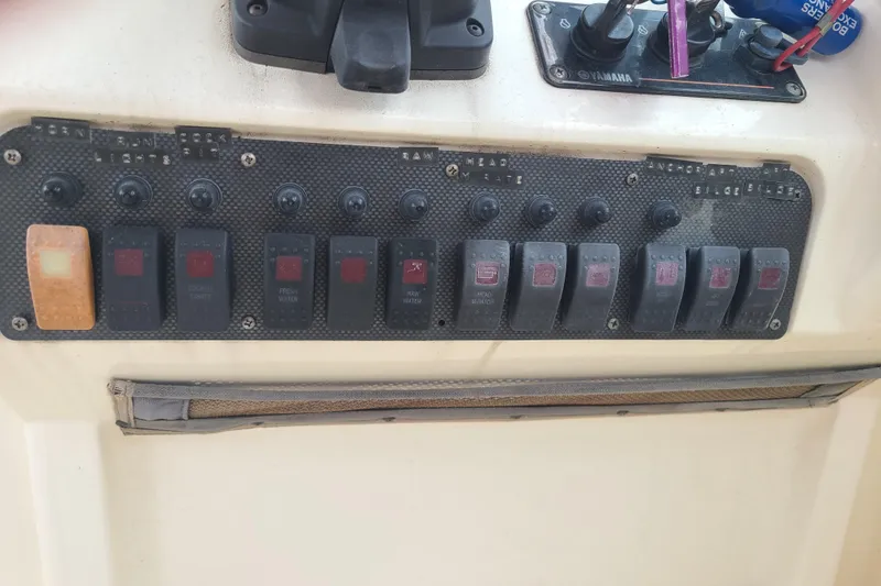 Slide: The Image of Control panel of a 2010 World Cat 290 DC boat with labeled switches. - 9