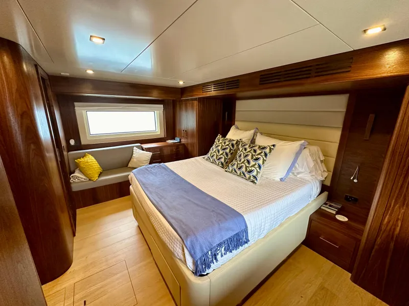 Slide: The Image of Luxurious 2021 Sirena 58 yacht bedroom with elegant wood finishes and cozy bedding. - 48