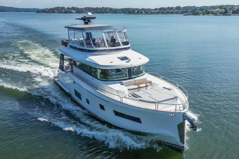 Slide: The Image of 2021 Sirena 58 yacht cruising on a serene lake. - 5