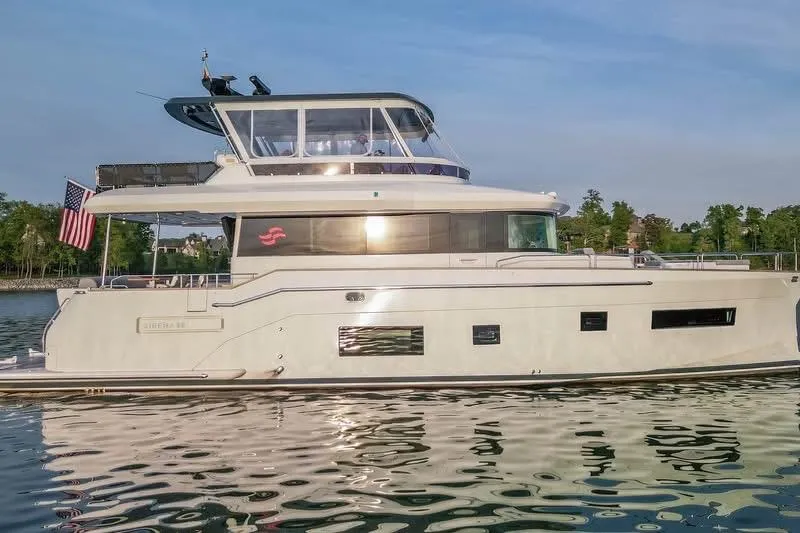 Slide: The Image of Luxury 2021 Sirena 58 yacht cruising on calm waters with scenic background. - 56
