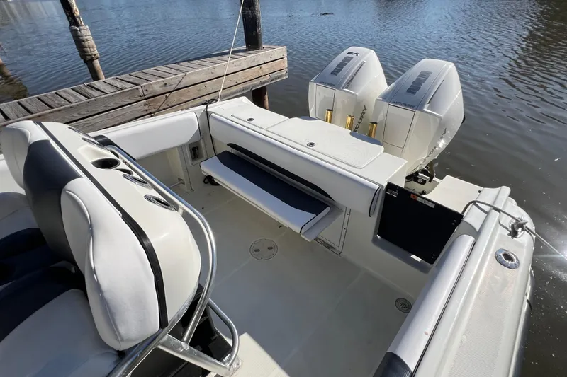 Slide: The Image of 2001 Hydra-Sports Vector 2600 CC boat interior with dual outboard engines at dock. - 11