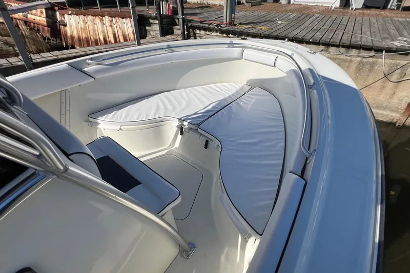 Slide: The Image of 2001 Hydra-Sports Vector 2600 CC boat with cushioned seating at the bow, docked. - 12