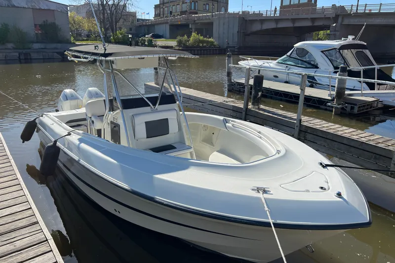Slide: The Image of 2001 Hydra-Sports Vector 2600 CC boat docked in a marina, featuring sleek design and twin engines. - 4