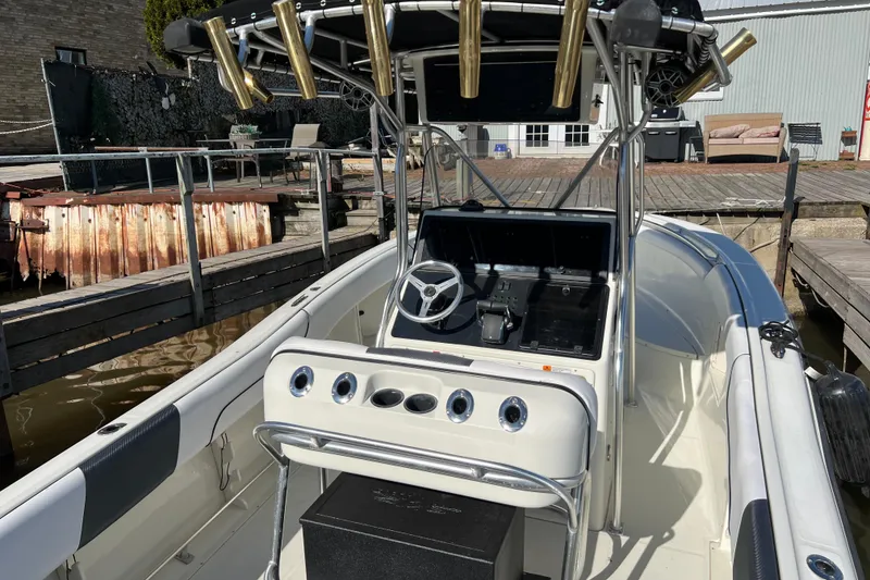 Slide: The Image of 2001 Hydra-Sports Vector 2600 CC boat interior with steering console and rod holders. - 6